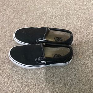 Very worn out black and white vans